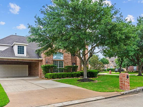 Beautiful CORNER LOT. Driveway features PORTE COCHERE in front of 2-car garage.