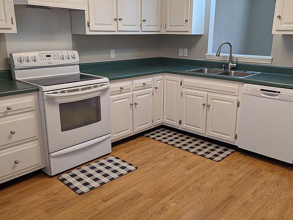 The kitchen is spacious with lots of cabinets and counterspace.