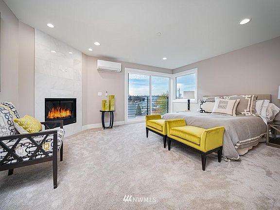 Magnificent master bedroom with fireplace, floor-to-ceiling windows to own deck.
