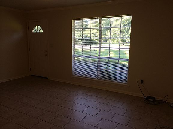 Another pic of living room also showing front door.