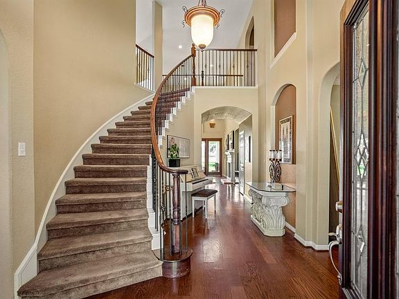 As you enter through a leaded glass front door into a 2 story entry you are greeted with an abundant space, gleaming wood flooring and natural light.