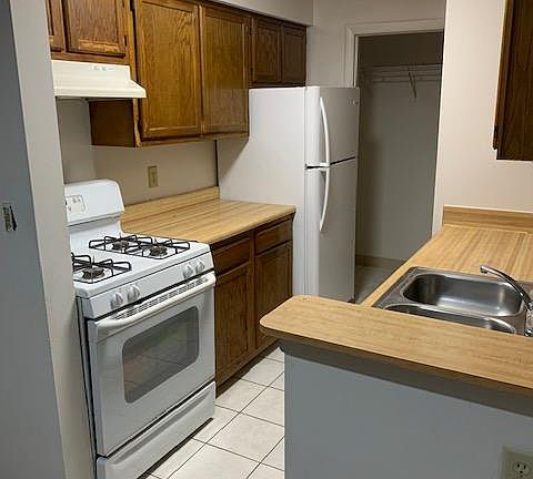 Ceramic tile in kitchen, entry and bathrooms. Door way at the end of the kitchen is the washer/dryer area. Fits a full size washer/dryer- not provided