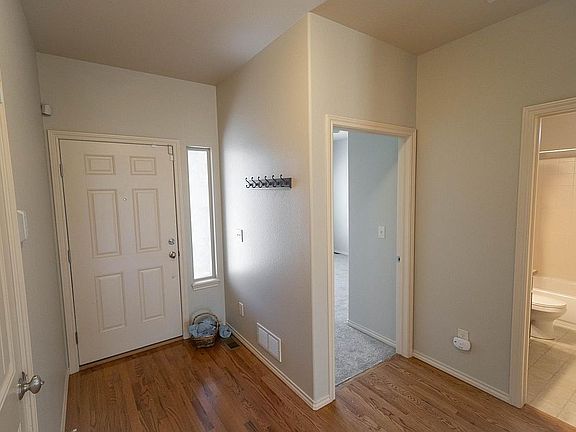 You've walked in the front door & turned back - BR on the right, then full bathroom just to it's right - door @ extreme left is to the garage