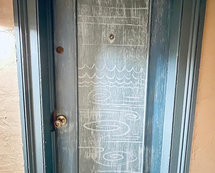 The apartment doors in the building represent the 4 main elements. This apartment is the element of water.