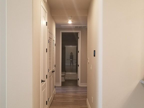 Long hallway separates the rooms, in unit washer / dryer behind the left door