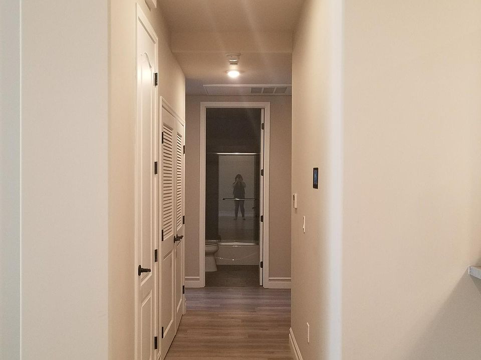 Long hallway separates the rooms, in unit washer / dryer behind the left door