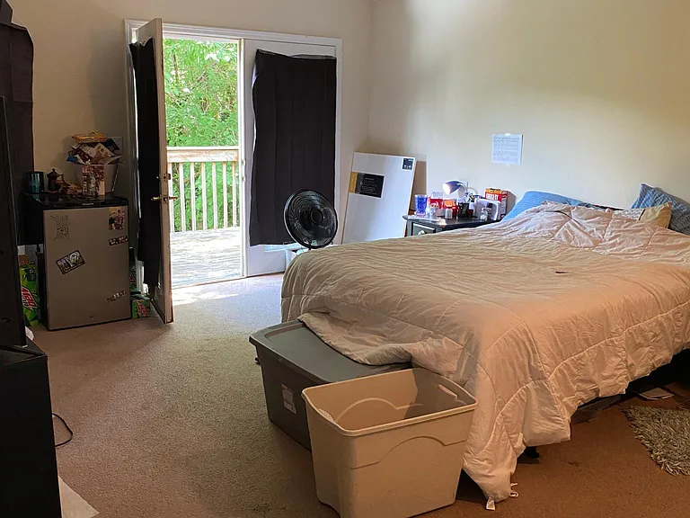 Upstairs master bedroom suite with cathedral ceiling and deck.