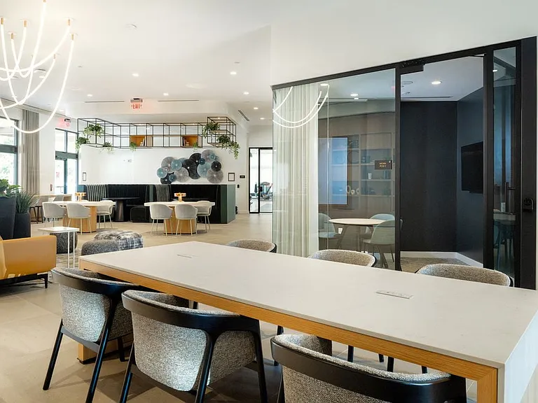Resident lounge with coworking spaces and private work pods