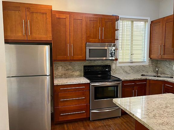 Updated kitchen with stainless steel appliances and granite countertops.
