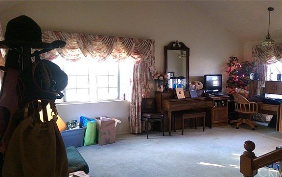 Enter into shared living/dining room with vaulted ceiling.