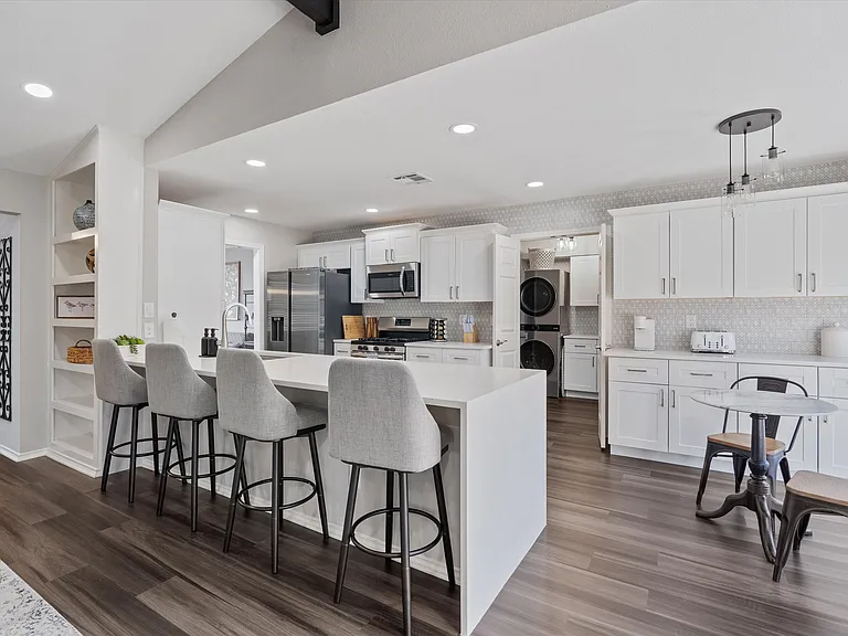 Open Concept Kitchen with all brand new appliances and Island Seating for 4 and breakfast table and extra storage in breakfast area.
