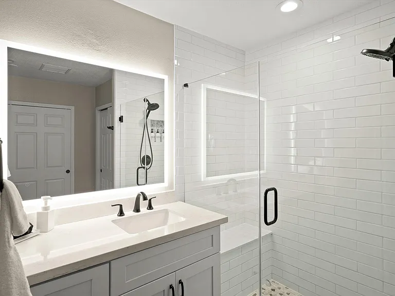 Primary #1 Bathroom with walk in shower, LED Mirror, separate water closet & 2 closets with a dresser for storage