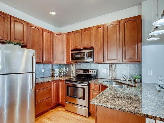 Modern kitchen with granite countertops and stainless steel appliances.