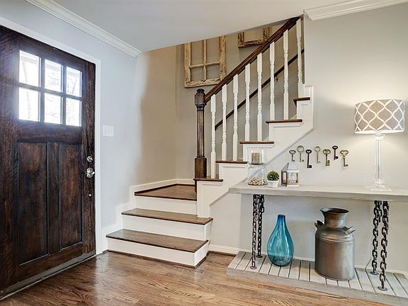 Welcoming entry opens to the dining room and offset stairs with wood treads.