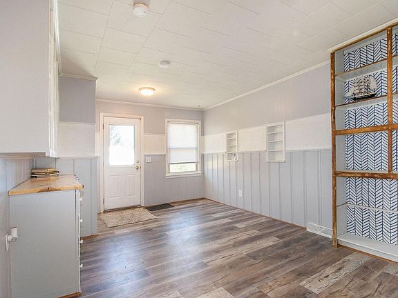 Office den with live wood edge counter tops and plenty of storage space. Entrance to laundry room and garage located in room (not shown)