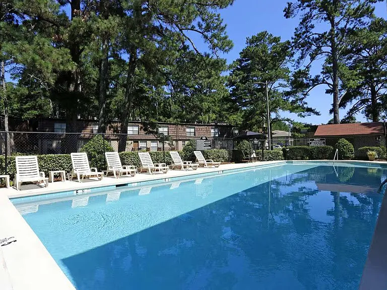 Unwind by the sparkling pool at Arbor Terrace, surrounded by lush landscaping and comfortable lounge chairs. This inviting outdoor space offers the perfect escape for relaxation and socializing. Schedule your tour today!