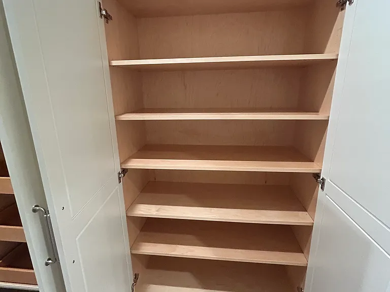 The third cabinet has adjustable shelves. This cabinet is closest to the back door to the garage and mudroom. Perfect Costco storage cabinet.