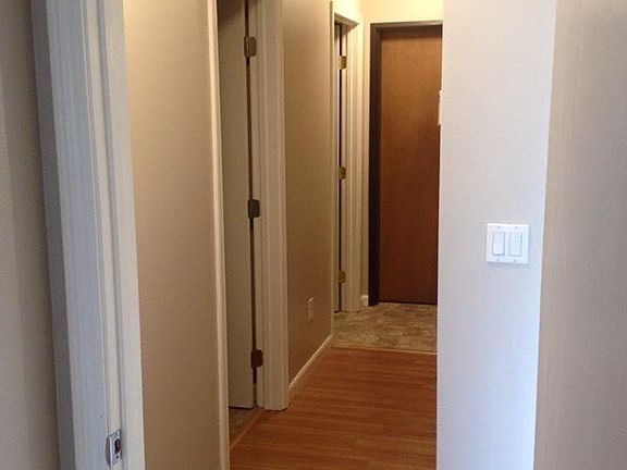 Hallway with doors to bathroom, laundry room & garage.