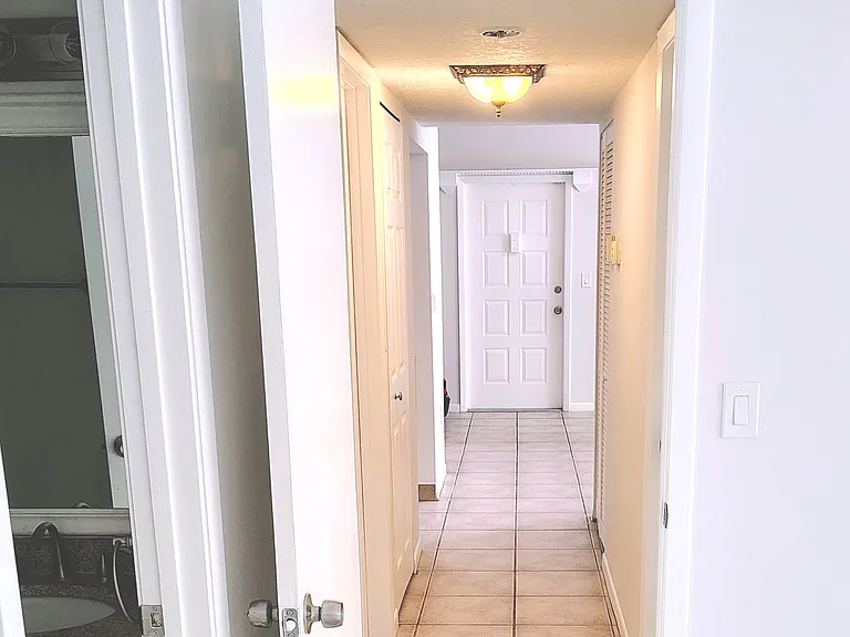 Hallway with W/D on left, A/C and water heater on right.