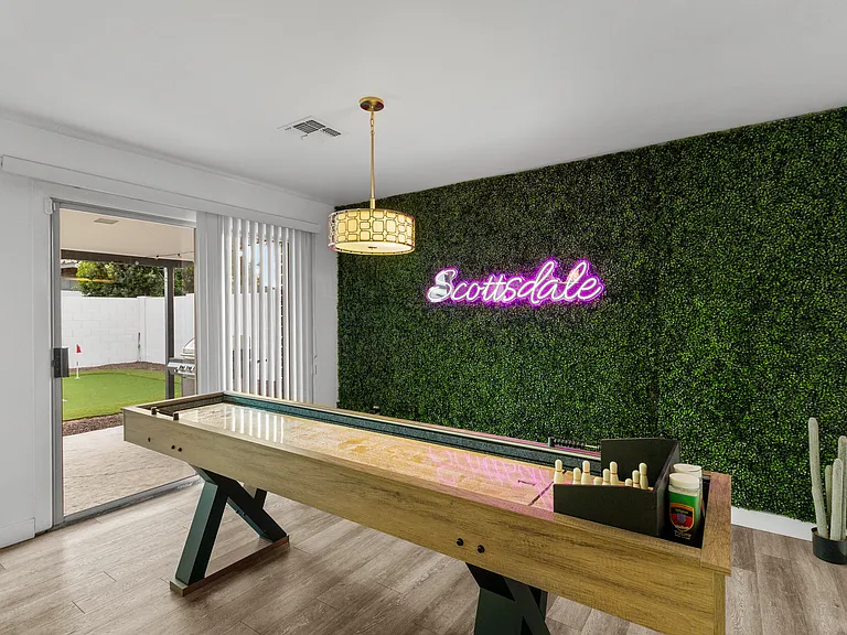 Game Room with Shuffleboard and Neon Art