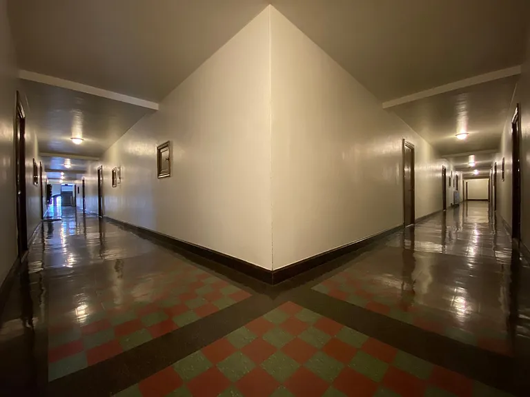 This unit is located at the corner of the building. This is the view of the hallway from the door of unit 116.