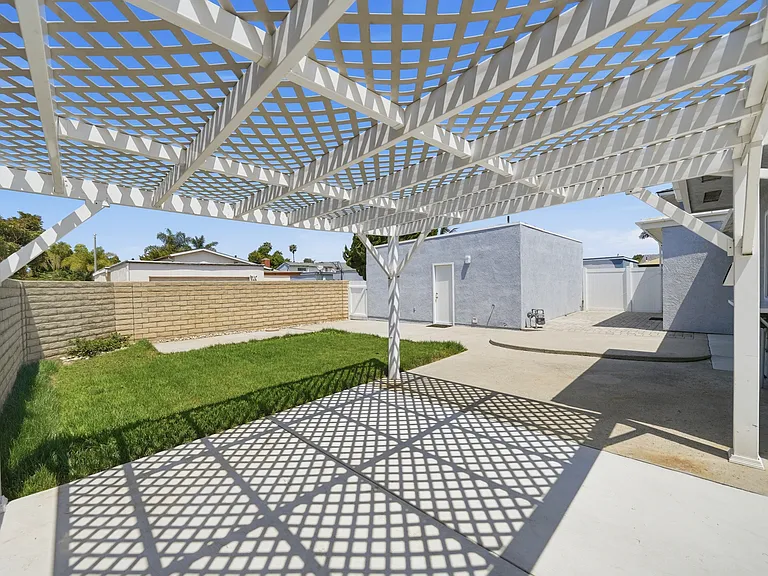 Expansive low maintenance backyard, and view of detached garage.