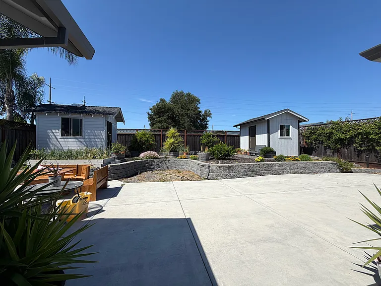 2 storage sheds and a planter box.