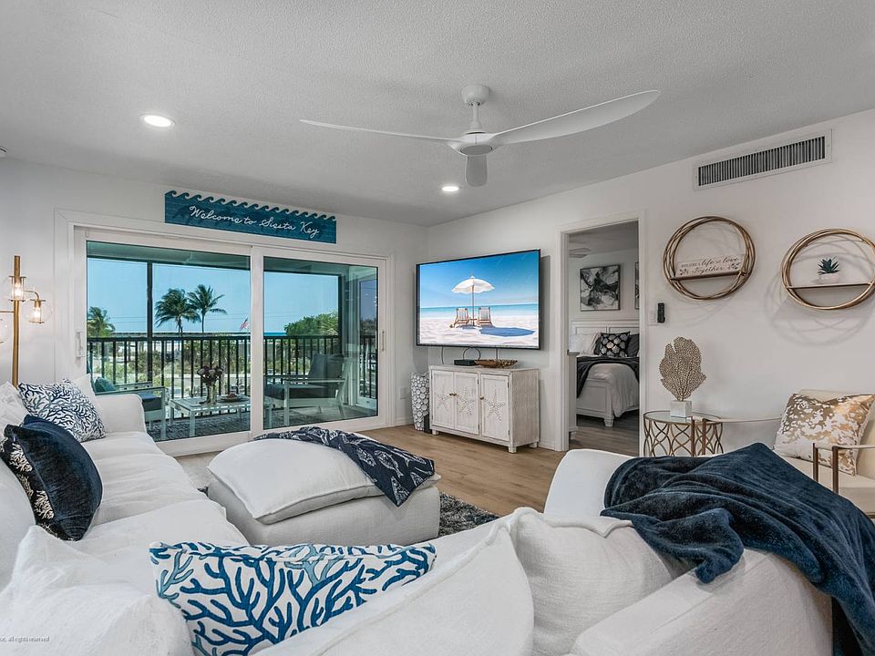 Living Room with Slider to the Lanai (with Amazing Gulf Views)!