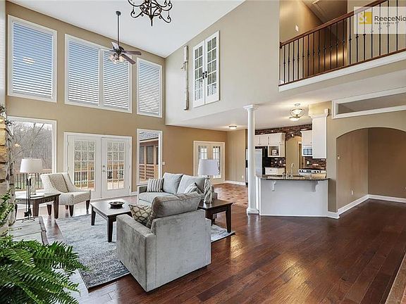 GREAT ROOM OPENS TO KITCHEN, DINING ROOM, AND LARGE OUTDOOR LIVING SPACE. BALCONY SHOWN IS HALL TO 2ND FLOOR BEDROOMS, 2ND LAUNDRY AND BONUS SPACE
