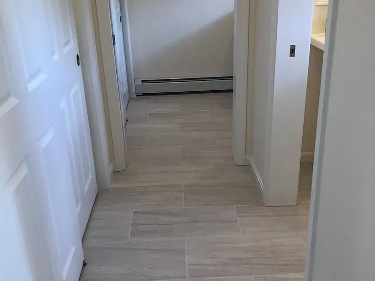 Passage from entrance to hall closet, guest washroom and laundry