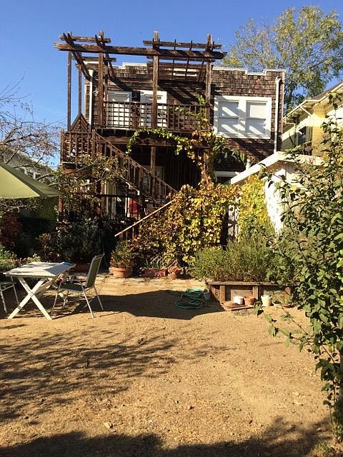 Backyard, looking towards the flat. Laundry/storage room is on the right.