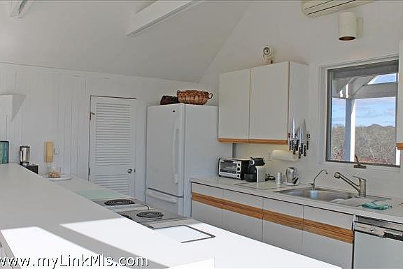 Kitchen open into living and dining room with access to screen porch.