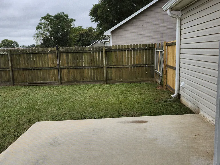 Cemented patio area; great for grilling, etc...; located next to covered screened porch.