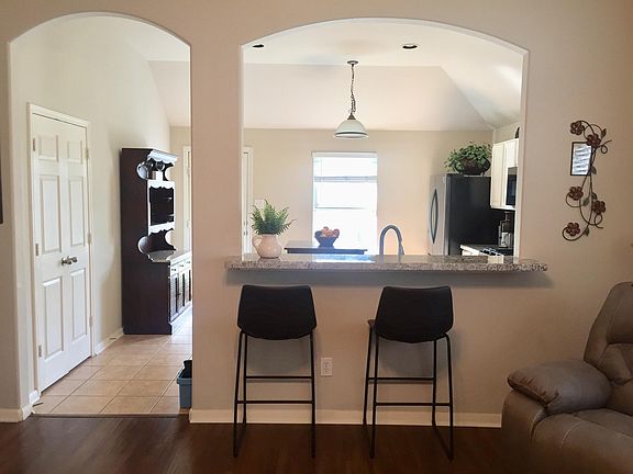 Bar seating open to the living room and kitchen
