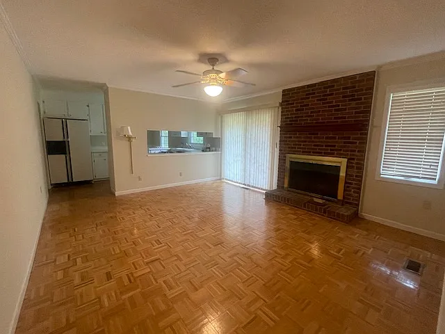 Family room (with fireplace), sliding doors to patio in rear of house, pass through opening to kitchen