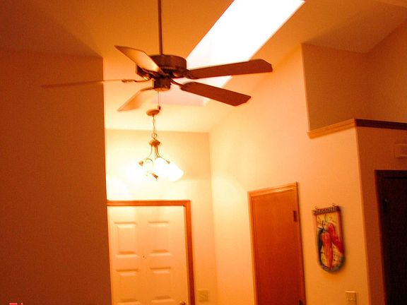 Tile entry, skylight, & beam in living rm w/ fan