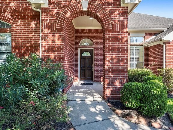 An arched walkway leads you to a cozy courtyard area, perfect for a bench placement, creating a sitting area to relax and wave to your neighbors as they pass by!