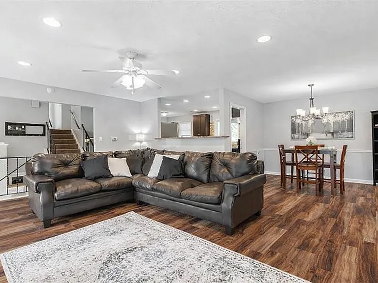 Open floor plan kitchen, dining, living spaces.