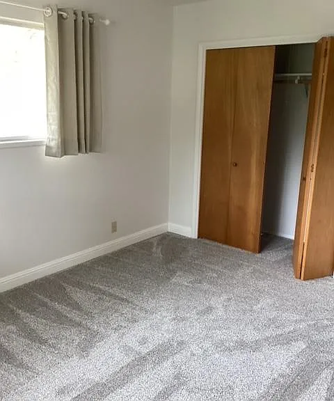 West bedroom (#2) with carpet throughout into the closet.