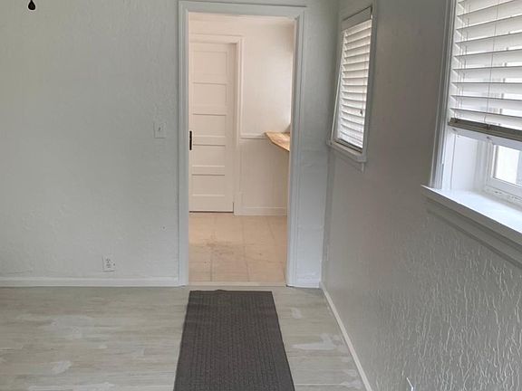 Coming into (front) living room with view of kitchen area in background