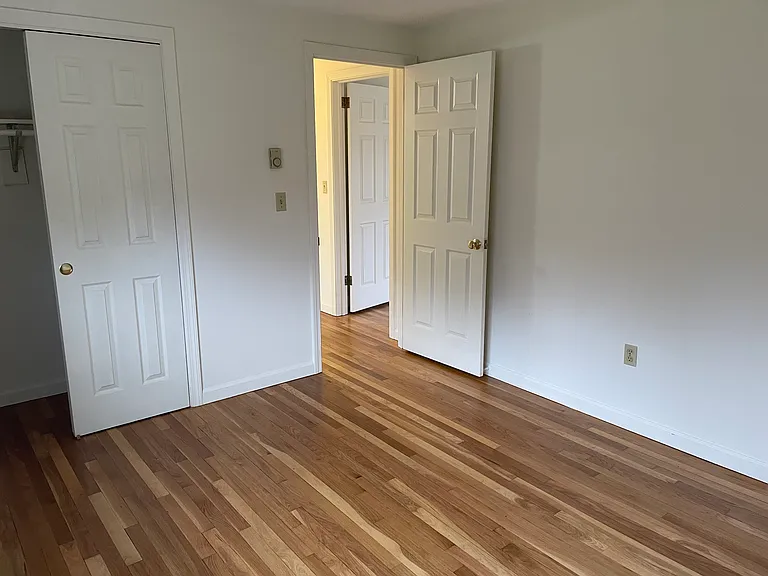 Exiting smaller bedroom with view to open doorway to master bedroom