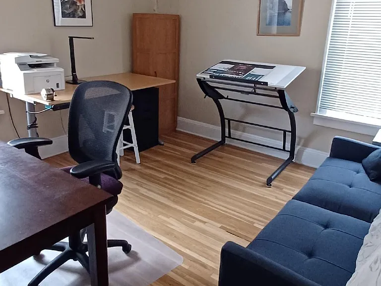 This bedroom is currently set up as an office/studio with a couch that converts to a bed. It could also be set up as a bedroom, depending on your needs. It is the brightest bedroom and has mini-blinds on the 2 south and west facing windows.