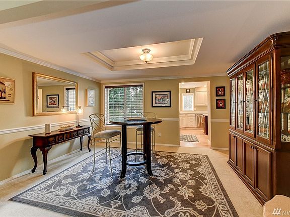 Dining room with trayed ceiling and extra chair railed trim. Large enough for a grand table and extra storage pieces.  