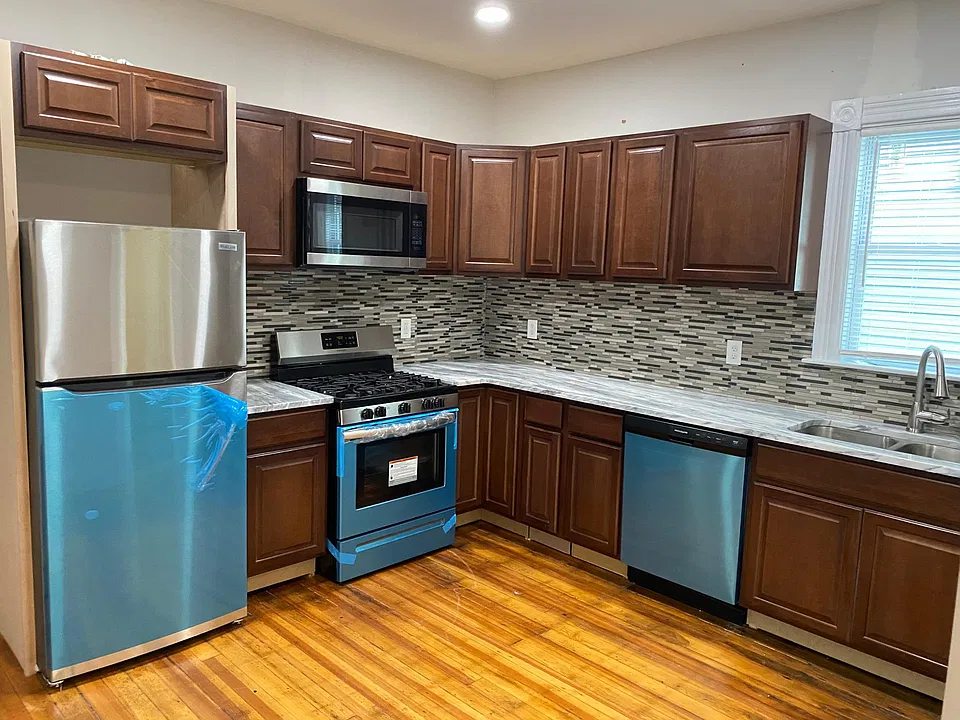 Kitchen with new stainless steal appliances. Marble counters, dishwasher and built in microwave