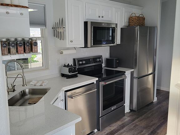 kitchen with granite countertop and stainless steel appliances.