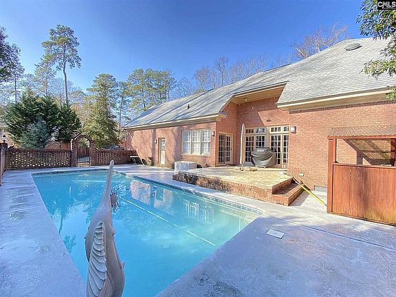Bricked pool deck in back