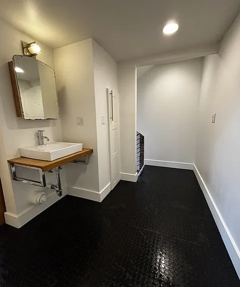 Durable rubber flooring in the hallway where the sink resides.