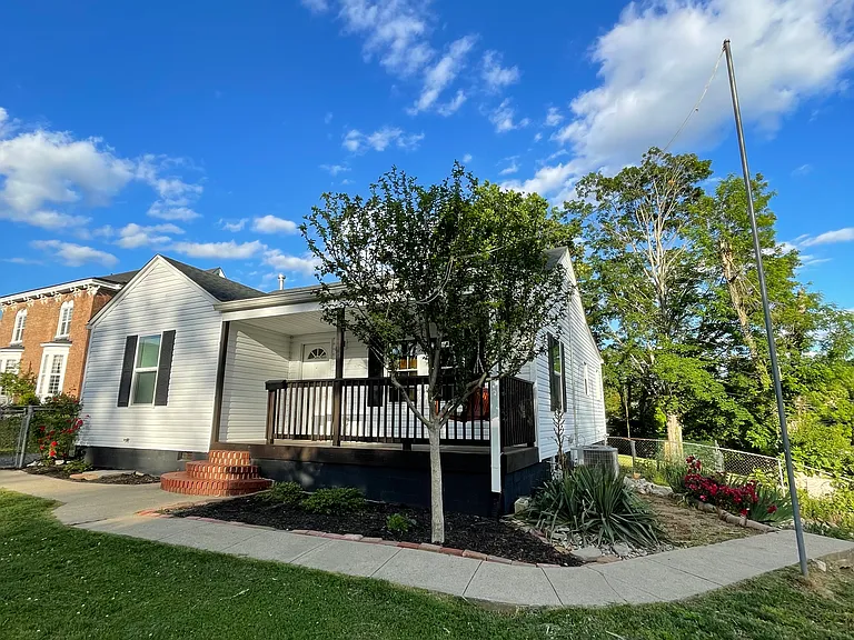 Corner lot with driveways in front and on the side of house.