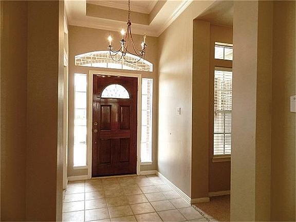 Stunning entry way with recessed ceiling and transom windows.