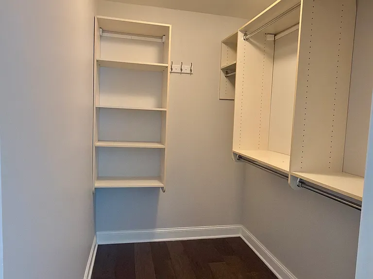 Primary bedroom walk in closet